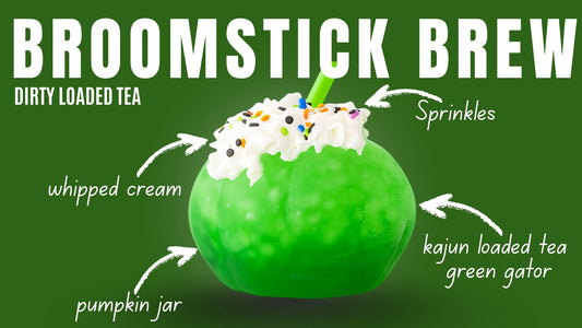 A drink made inside a green pumpkin jar with whipped cream on top. Text reads "Broomstick Brew Dirty Loaded Tea Recipe (whipped cream, sprinkles, kajun loaded tea green gator, pumpkin jar)"