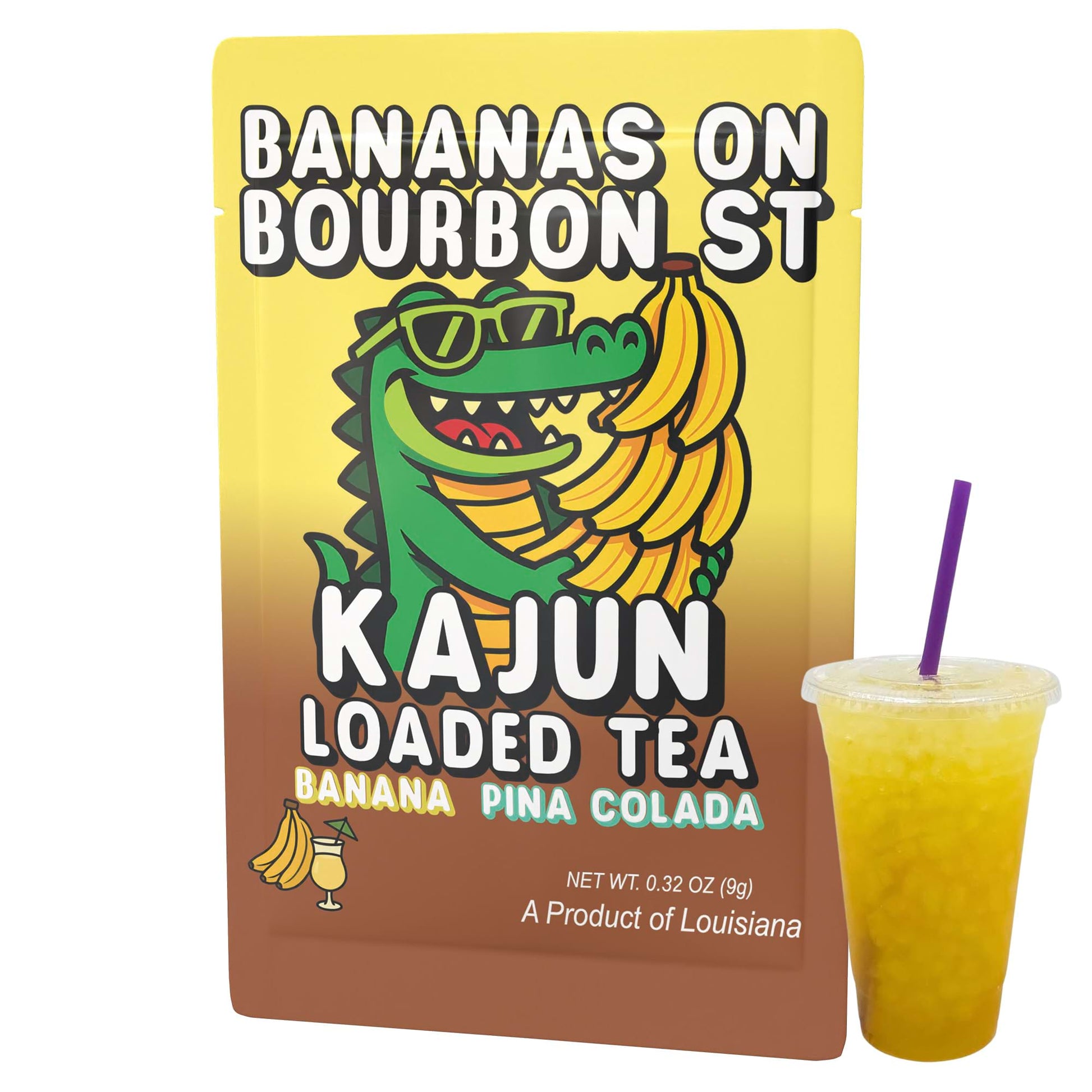 Direct product image showing a single packet of the Kajun Loaded Tea Bananas on Bourbon St mix, standing upright next to a clear plastic cup containing the mixed, yellow-gold drink with a purple straw. 