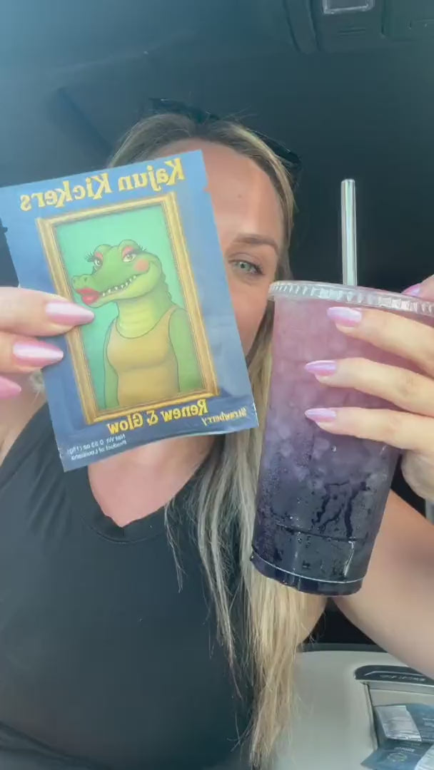 Woman sitting in a car holding a purple iced drink and a packet that reads Kajun Kickers.
